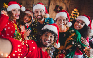 people successfully navigating holiday stress looking happy at a christmas party