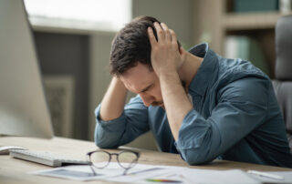 man stressed out at desk